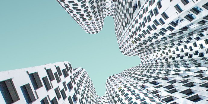 looking up at white wavy shaped building