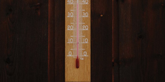 wood background with wooden temperature stick on it