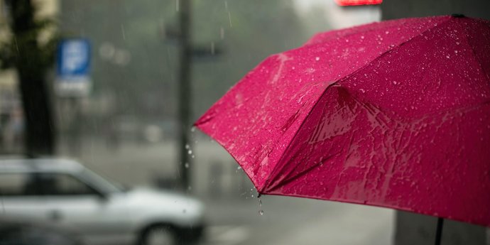 Red umbrella with rain on it