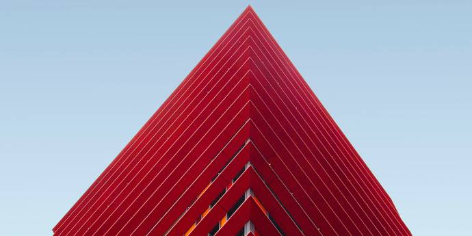 Red building with triangle peak against blue sky
