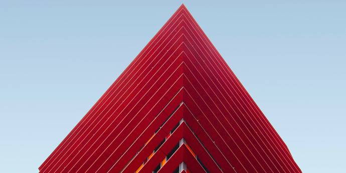 Red building with triangle peak against blue sky