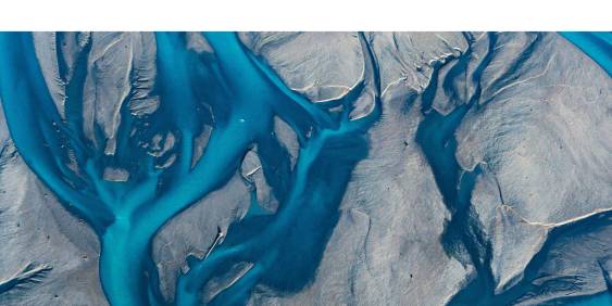 aerial view of a bright blue braided river