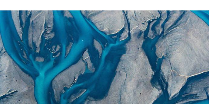 aerial view of a bright blue braided river
