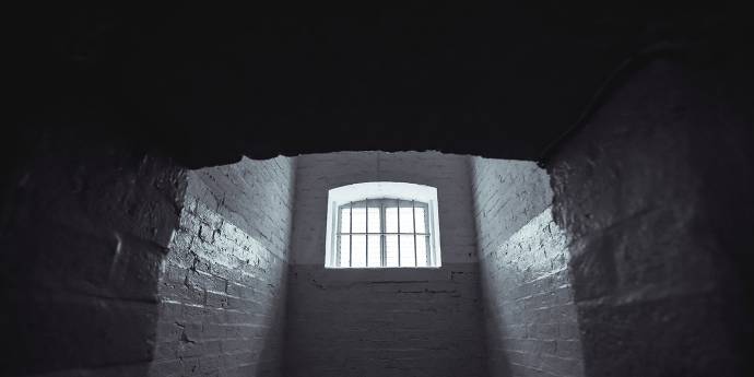 looking up at a window in an old dark abandoned building 