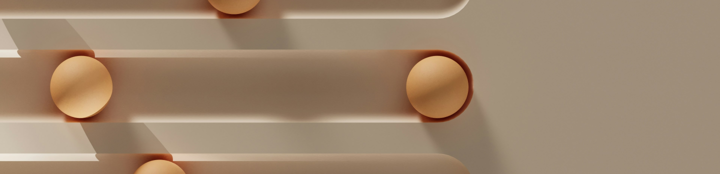 A wall featuring four white pipes adorned with gold dots.