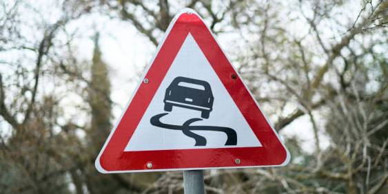 A sign featuring a graphic of a car, indicating traffic regulation.