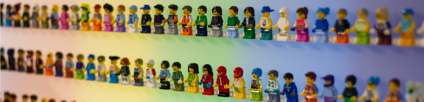 A collection of Lego figures mounted on a wall, showcasing diverse characters and designs in a well-lit room.