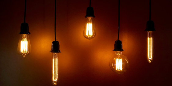 A cluster of five light bulbs hanging from the ceiling, providing ambient lighting to the room.