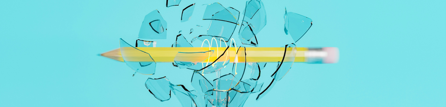 A broken pencil rests inside a light bulb, symbolizing creativity