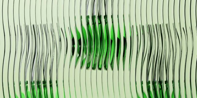 A green glass bottle stands upright against a plain white background.
