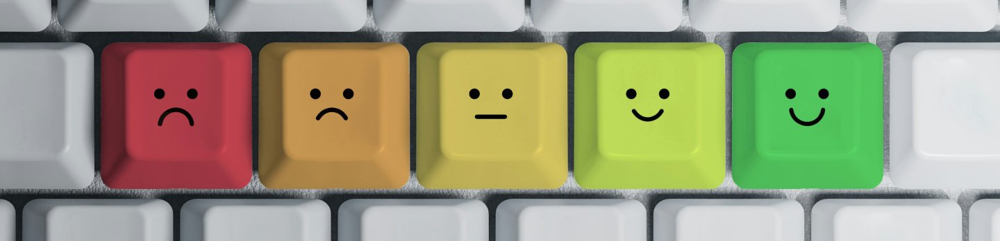 A collection of five vibrant keys, each adorned with a cheerful smiley face, displayed side by side.