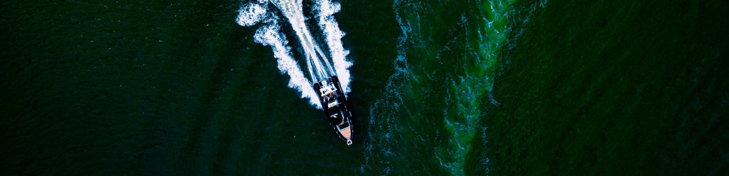 A boat navigating through calm waters, surrounded by a serene landscape.