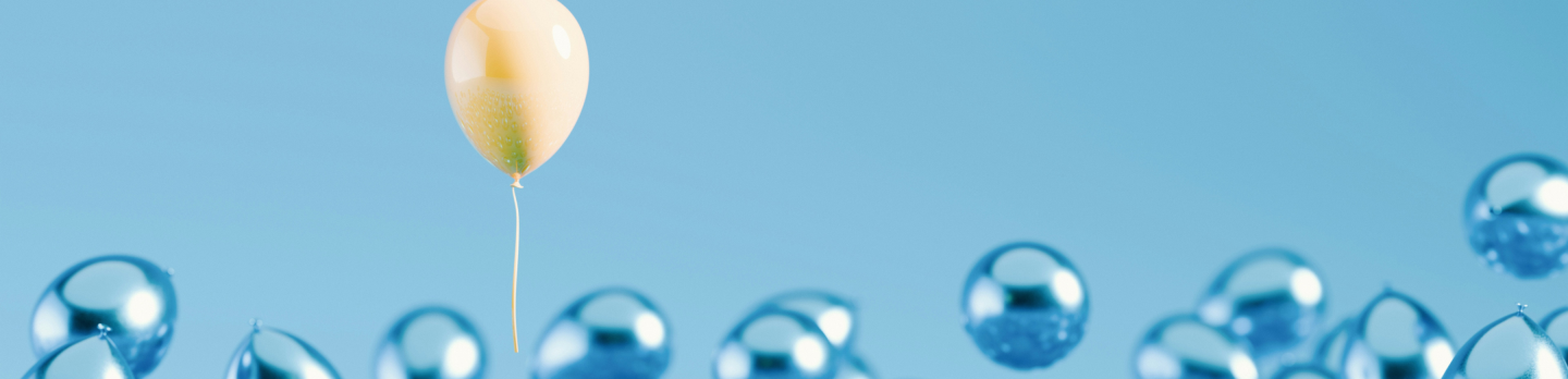 A single yellow balloon rises above a cluster of blue balloons against a light blue background, creating a sense of uniqueness and contrast.