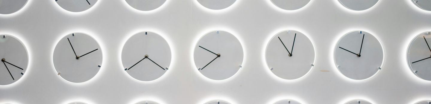 A grid of clocks with black hands on a white background, each showing different times. 