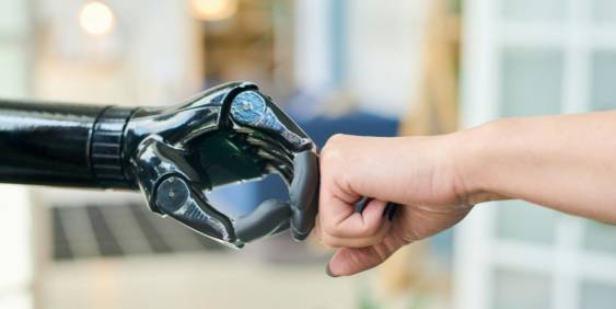 A human hand grips a robotic hand, illustrating the interaction between people and advanced technology.