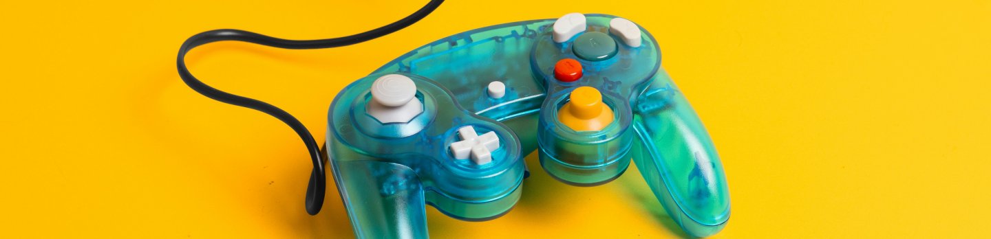 A game controller displayed on a yellow surface, showcasing its sleek design and gaming functionality.