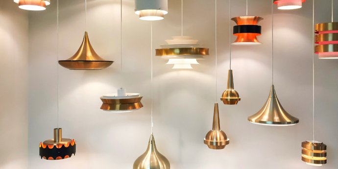 A display of hanging lamps in multiple colors, showcasing a variety of designs and styles.