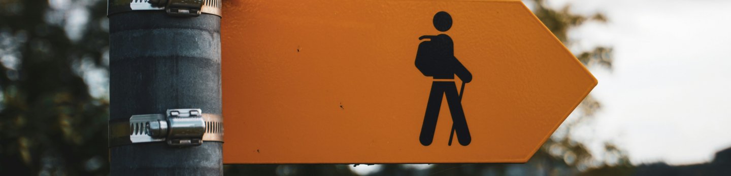  Close-up of a sign displaying the word "walk" in bold letters against a contrasting background.