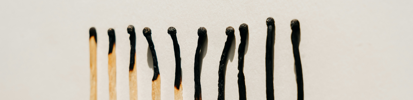 A row of wooden matches neatly arranged, showcasing their uniform length and striking tips.