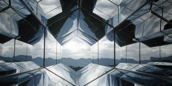dark hexagonal architecture looking out to the view of nature