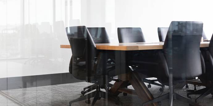 Board room table with empty chairs