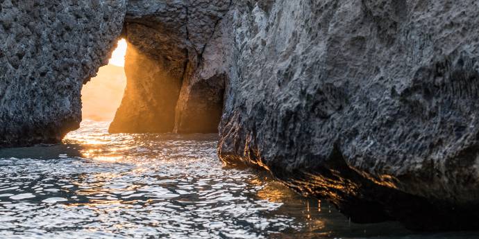 Cove on the sea with sunlight peaking through