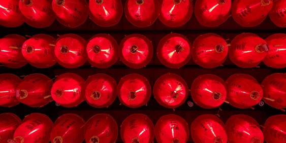 Array of red alert lights against black wall