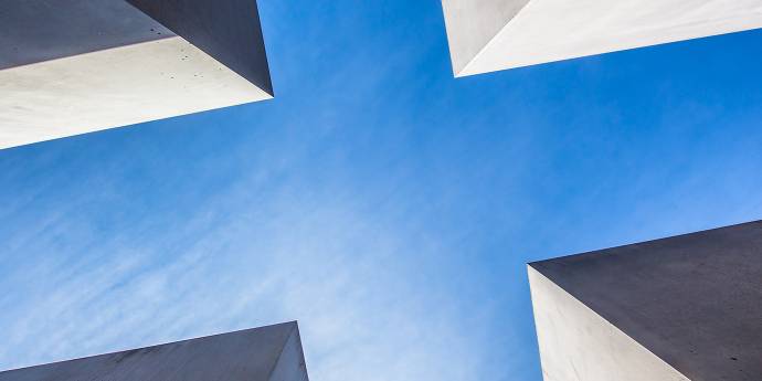 Looking up at the sky between four buildings