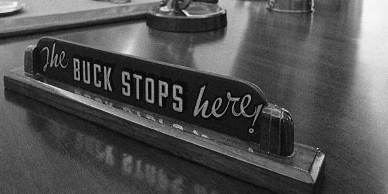 Desk sign with printed words the buck stops here!