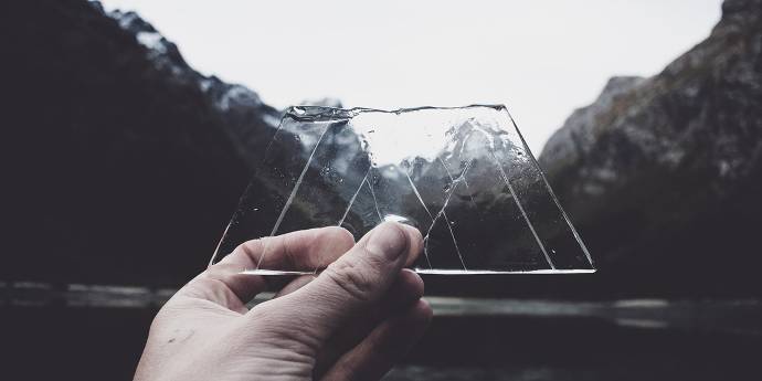 mountain scenery through piece of ice