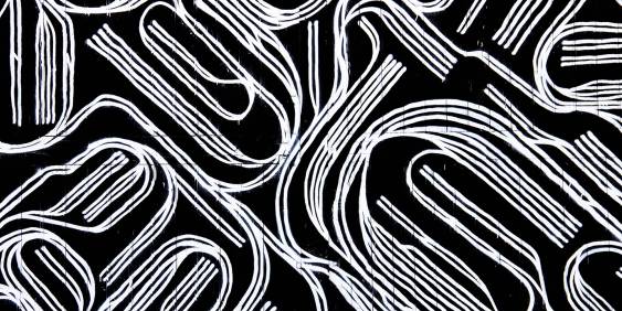 white thread in a pattern on black background 