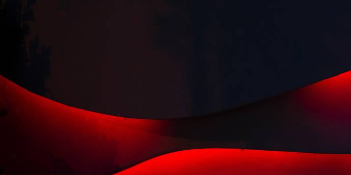 Red shapes against a black background