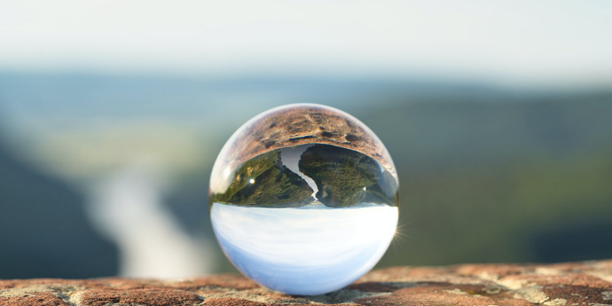 glass ball reflecting sky and nature