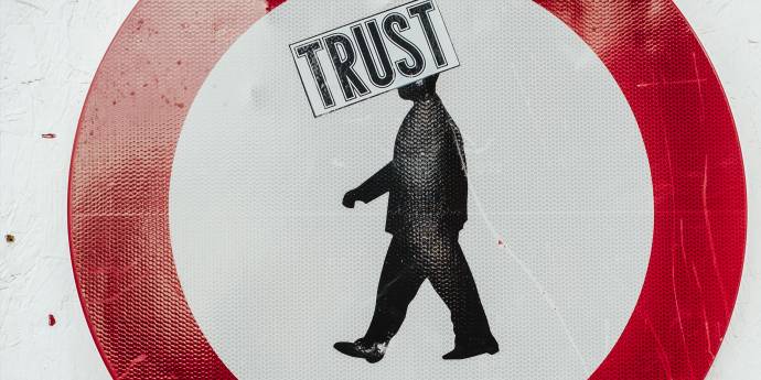 Graphic of red circle with man inside and trust sign