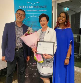 Frances Bates-Crisp receiving her award with Johnny Louie and Dee Desai from award sponsor, Stellar Library.