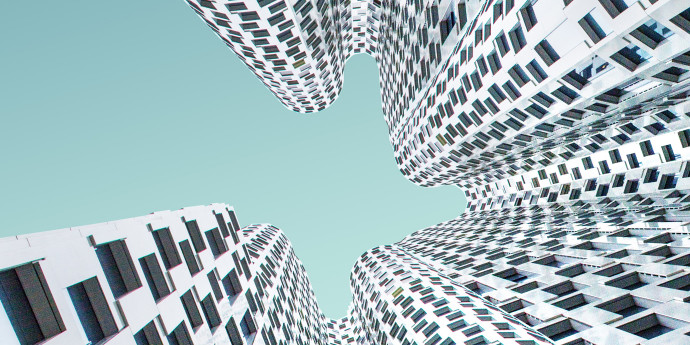 looking up at white wavy shaped building