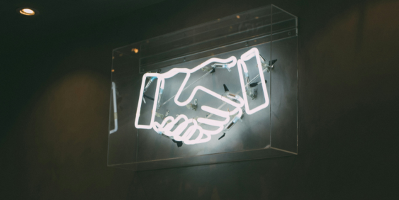 Neon sign of a handshake