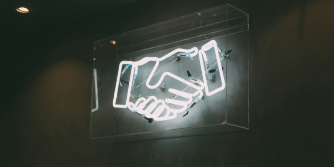 Neon sign of a handshake