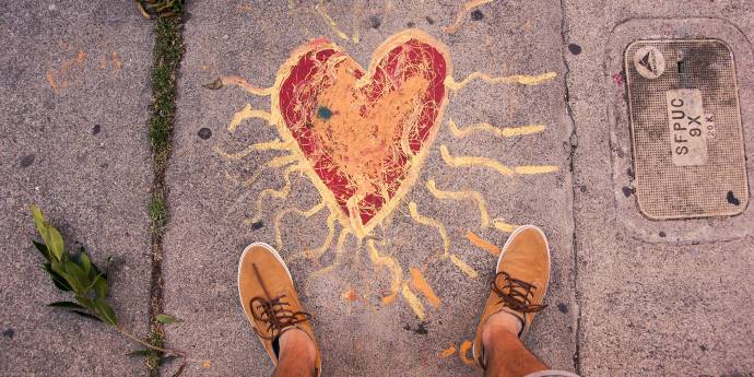 Looking down at a heart painted on pavement