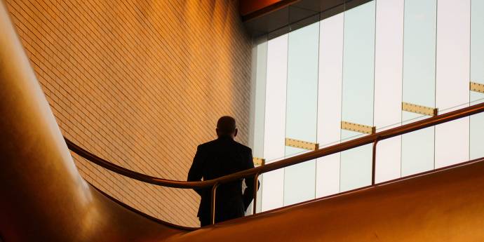 Business person standing on mezzanine floor