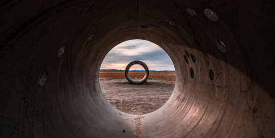 perspective through pipe with landscape background