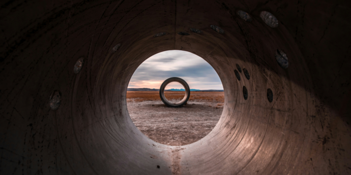 perspective through pipe with landscape background