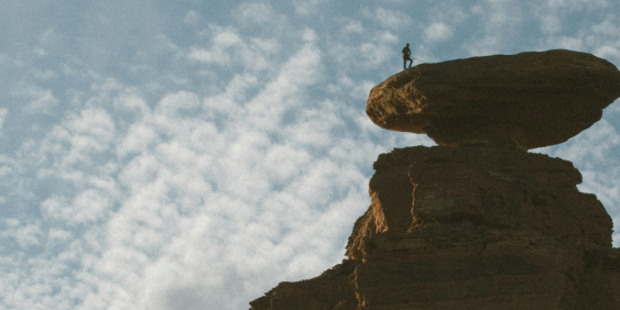 man at the top of a mountain