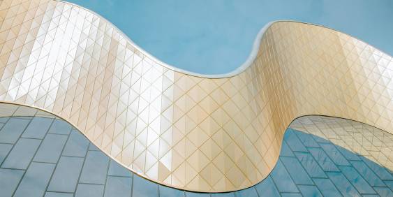 Organic shaped golden roof line of a building 