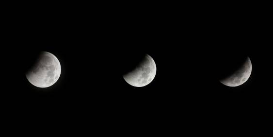The moon shown in three phases against a black sky