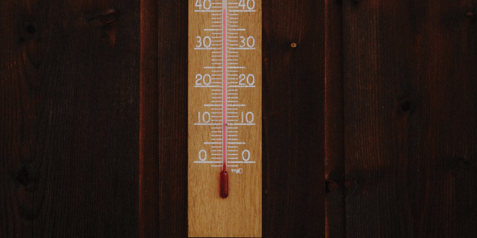 wood background with wooden temperature stick on it