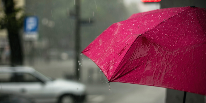 Red umbrella with rain on it