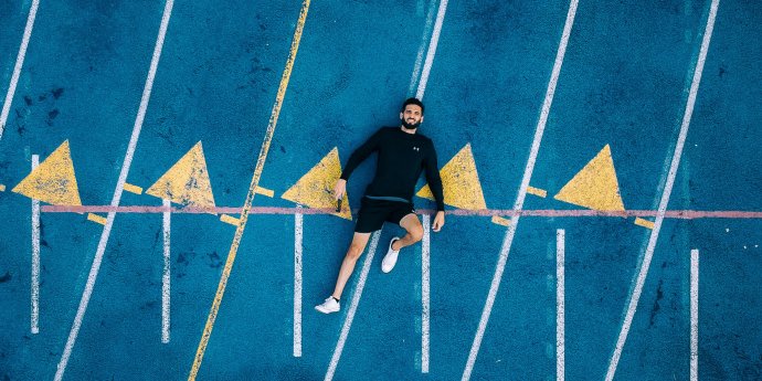 guy lying down on painted concrete