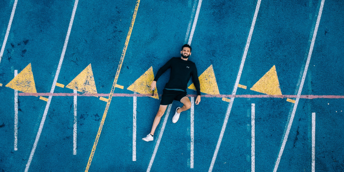 guy lying down on painted concrete