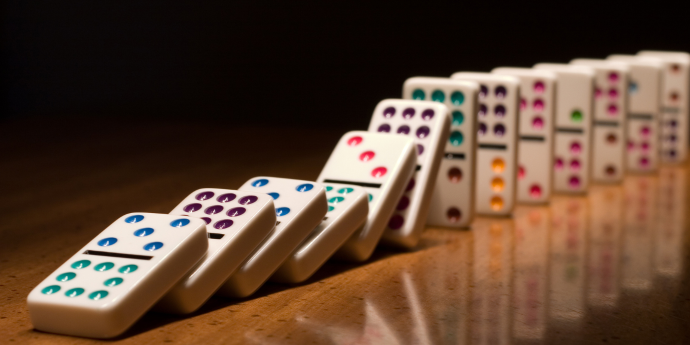 Dominoes falling on a table